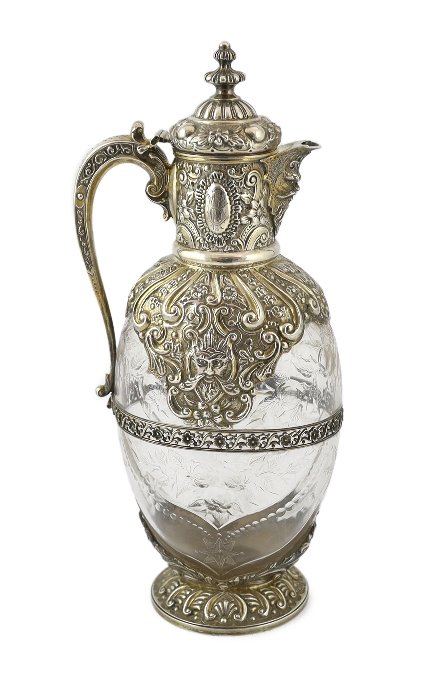 An ornate late Victorian silver mounted cut glass claret jug, by Charles Edwards